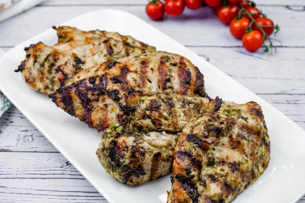 Grilled Lime-Garlic Chicken Breasts on a white plate.