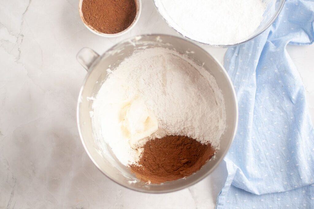 Adding sugar and cocoa.