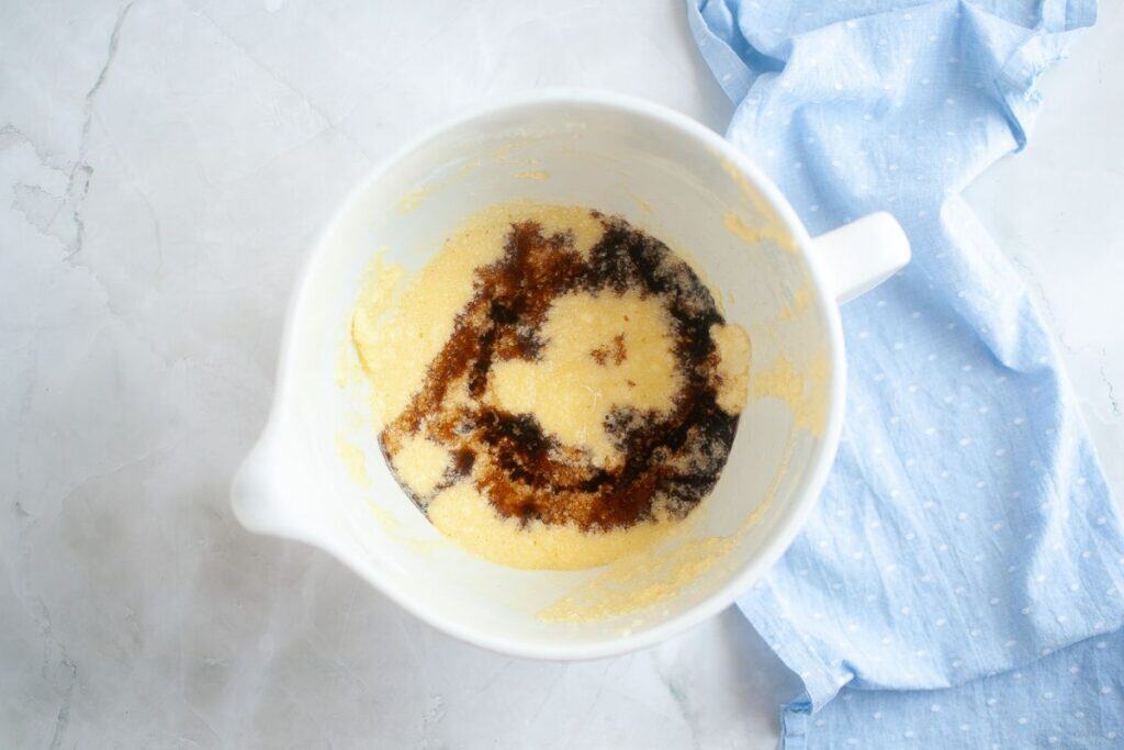Adding vanilla extract to the mixture.