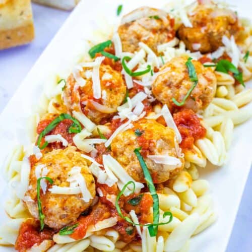 A white plate with Chicken Parmesan meatballs.