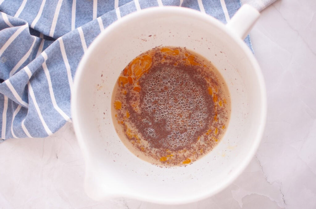 Overhead shot of melted brown butter in a white bowl.