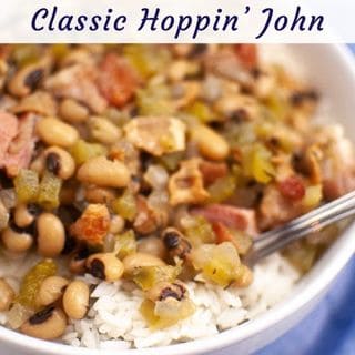 A close-up of Classic Hoppin' John, a dish of black-eyed peas, rice, and ham in a white bowl.