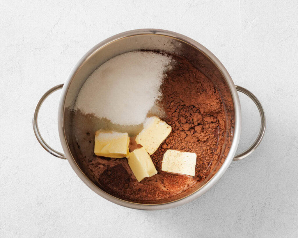 Preparing to combine the sugar, milk, butter, and cocoa powder in a medium saucepan.