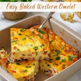 A slice of Easy Baked Western Omelet being lifted from a square baking dish with a spoon.