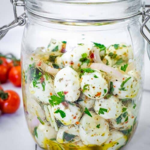 Herb-Marinated Mozzarella Balls on a jar.
