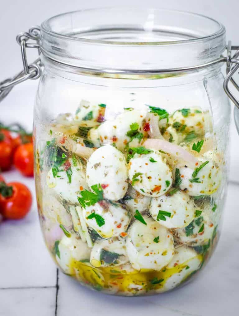 Herb-Marinated Mozzarella Balls on a jar.