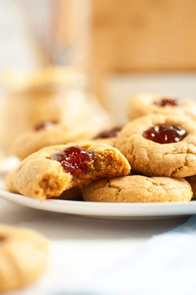Close up of a plate of peanut butter cookies with jam
