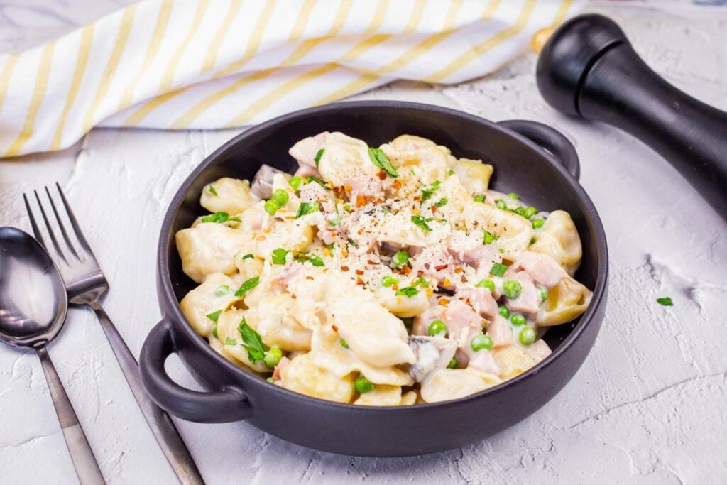 Horizontal image of Skillet Cheese Tortellini with Ham & Peas.