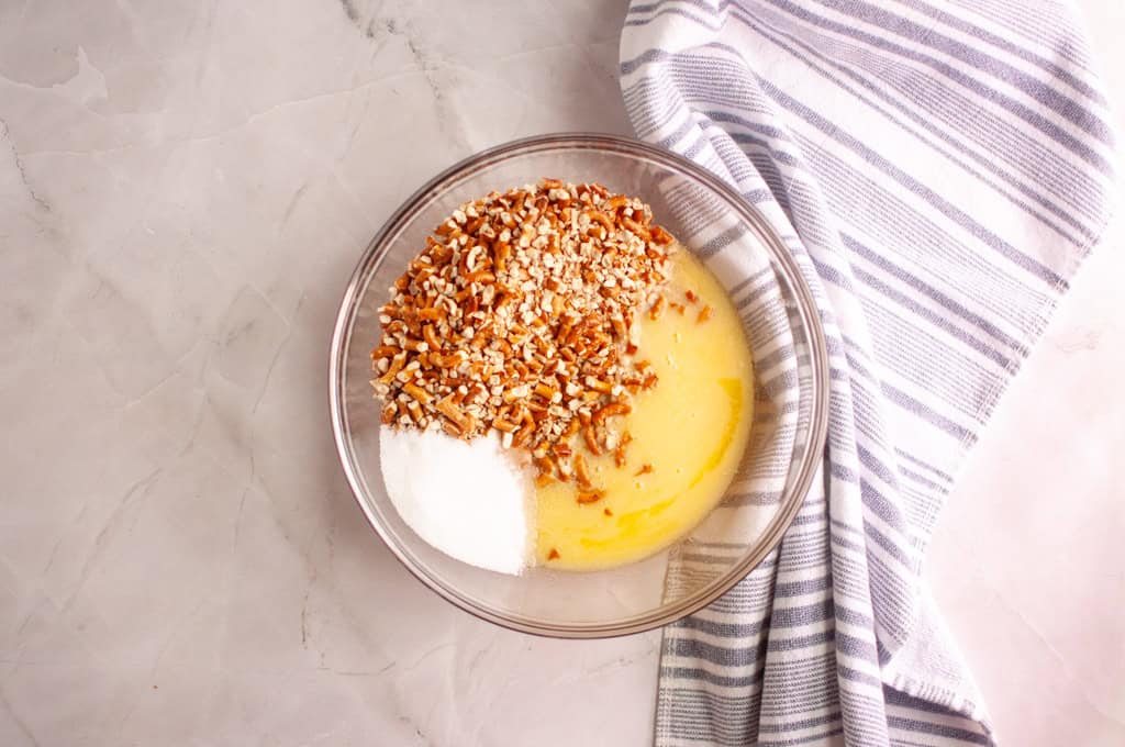 Preparing to combine crushed pretzels, melted butter, and sugar in a large mixing bowl.