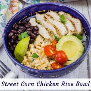 A colorful Street Corn Chicken Rice Bowl with grilled chicken, corn salad, black beans, avocado, tomatoes, lime, and cilantro.