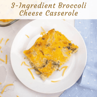 A slice of broccoli cheese casserole on a white plate, shown from above. Shredded cheese is scattered nearby on a white surface.