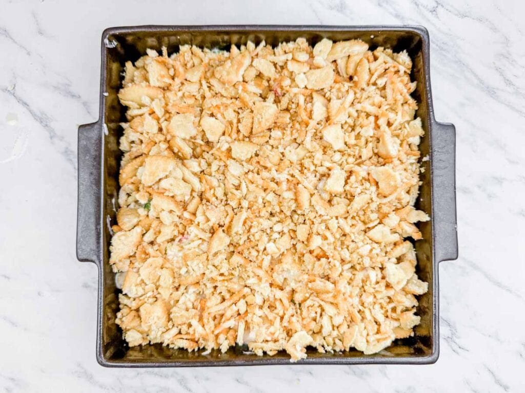 A casserole dish filled with chicken and cheese.