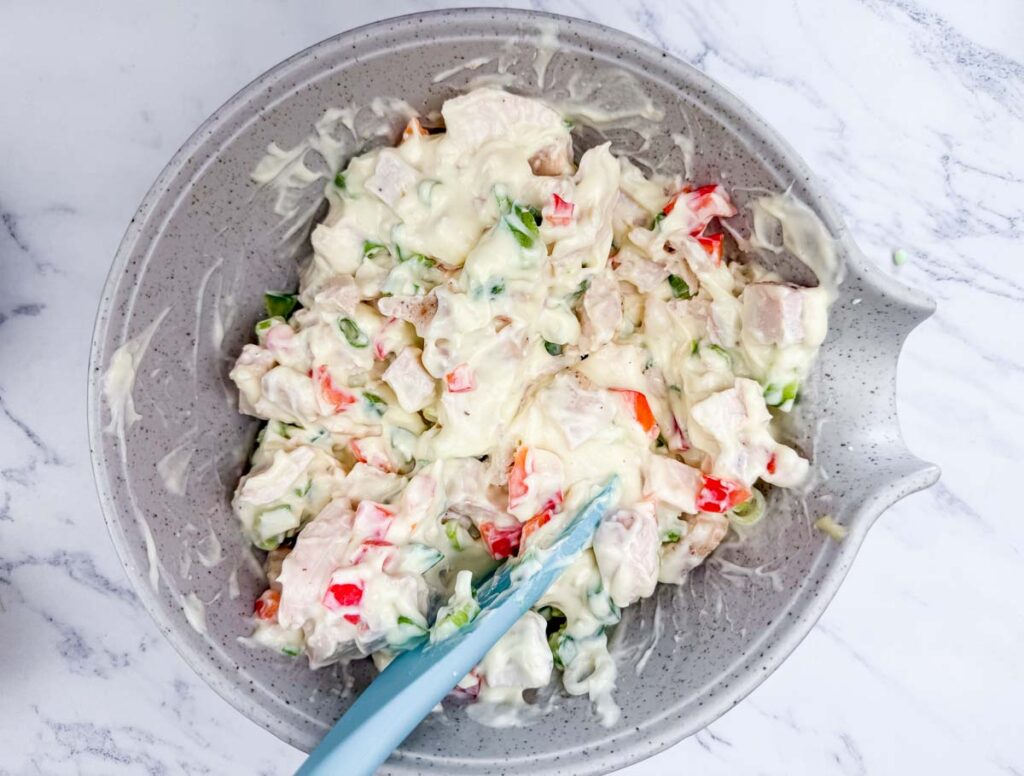 A bowl filled with chopped up apples and nuts.