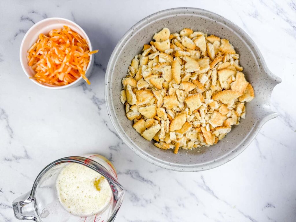 A bowl of chicken salad with a blue spoon.