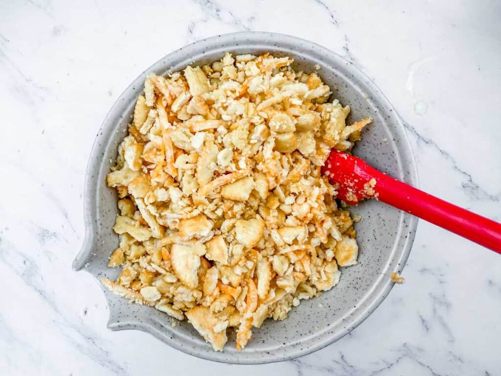 A bowl filled with chopped up apples and nuts.