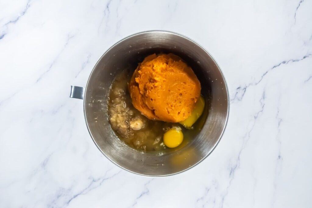 Mixing bowl with pumpkin puree, eggs, and other wet ingredients before combining.