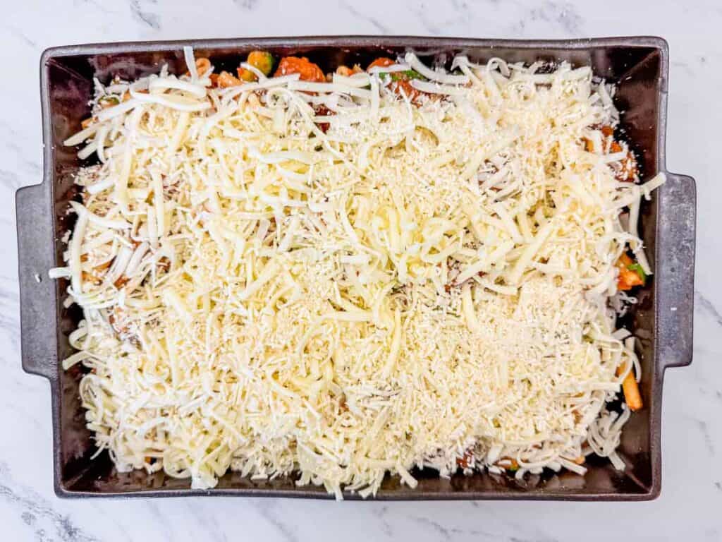 Sprinkle the mozzarella cheese evenly over the top, then add the parmesan for that golden crust.