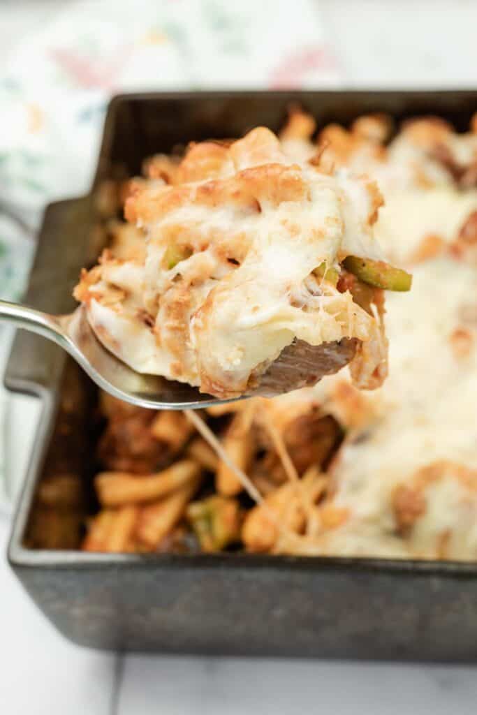 Close-up shot of a spoonful of Cheesy Meatball Casserole.