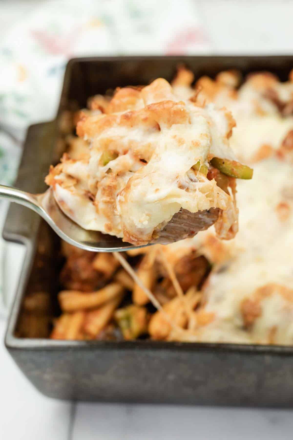 Close-up shot of a spoonful of Cheesy Meatball Casserole.