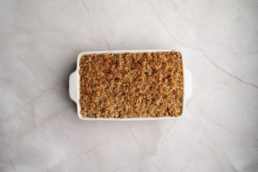 Crunchy baked crumble topping in a white baking dish.