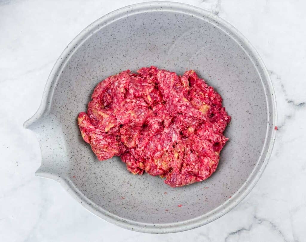 Combine the ground beef, bread crumbs, egg, dehydrated onion, and salt in a large mixing bowl.