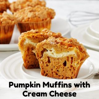 Juicy pumpkin muffins with creamy cheese filling on a white plate.