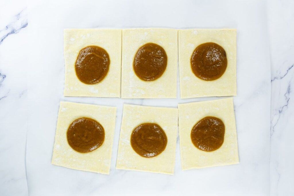 Puff pastry squares topped with spoonfuls of pumpkin filling.