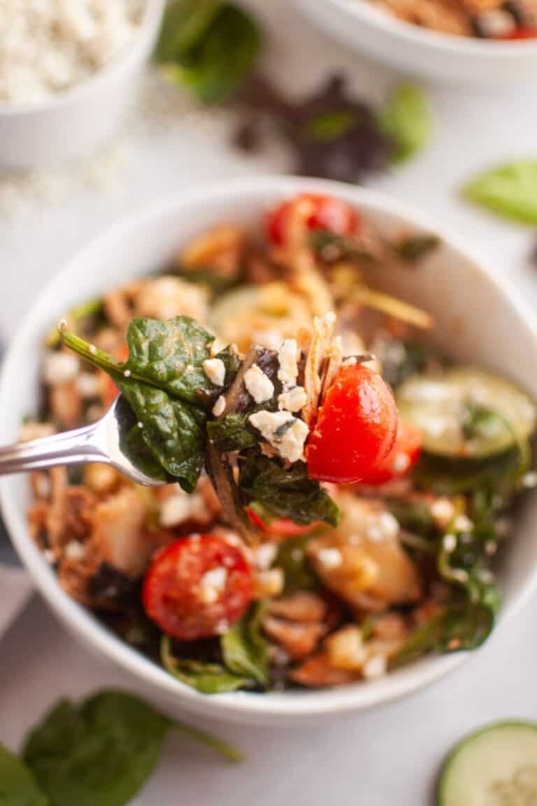 A spoonful of Buffalo Chicken Salad with Blue Cheese Dressing from the white bowl.