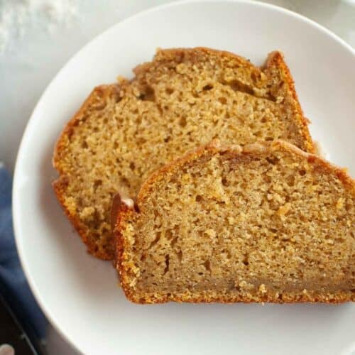 Two slices of Butternut Squash Loaf with Spiced Icing on a white plate.