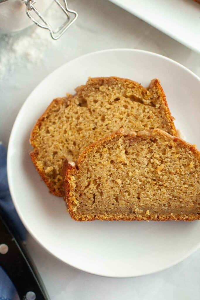 Two slices of Butternut Squash Loaf with Spiced Icing on a white plate.