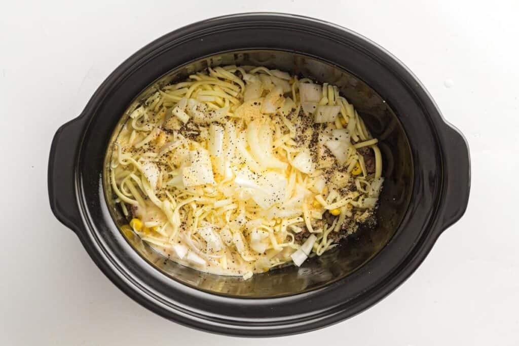 Creamy ramen with eggs, onions, and black pepper in a slow cooker.