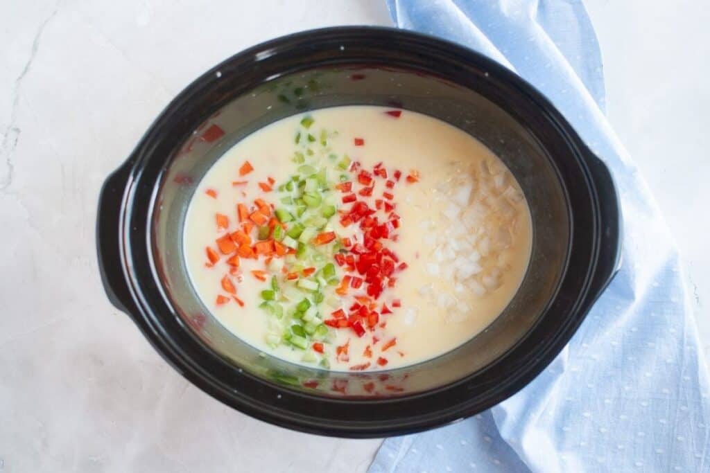 Stir in the diced onion, celery, carrots, and red bell pepper.
