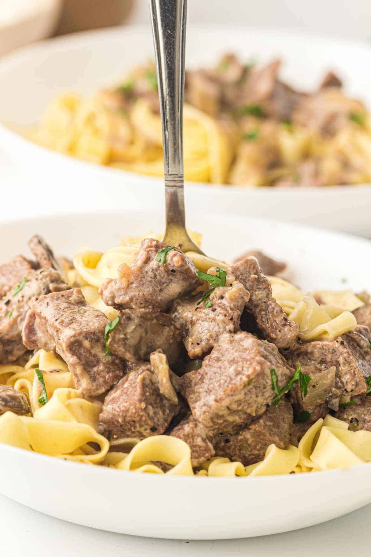 Beef stroganoff dish featuring tender beef, creamy sauce, and pasta.