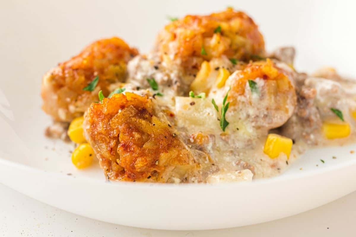 Slow cooker cowboy casserole with melted cheese, beans, and ground beef.
