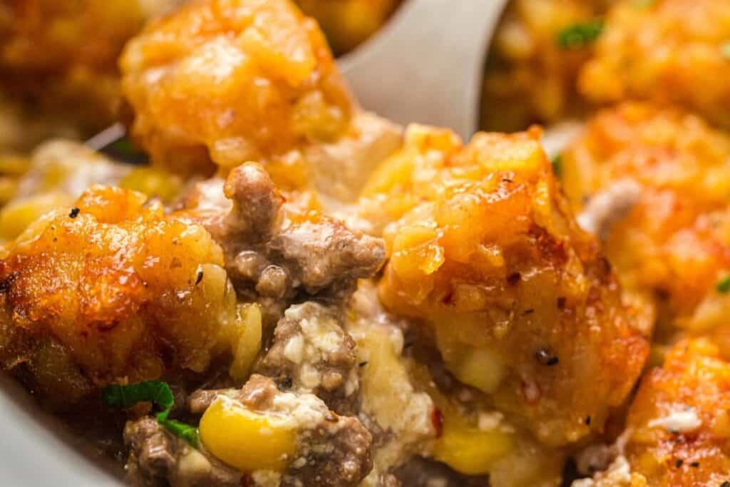Delicious cheesy Cowboy Casserole with beef, vegetables, and melted cheese. Perfect for snacks and parties.