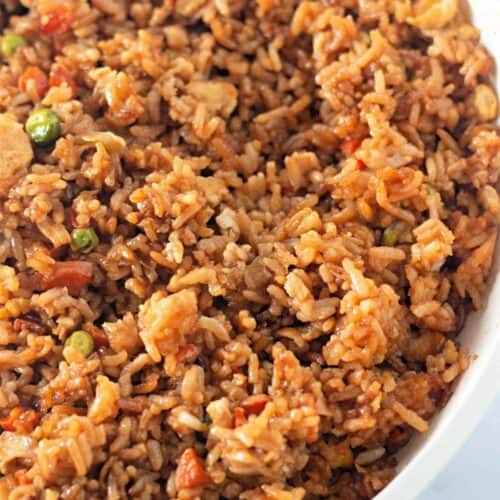 A white bowl filled with Fried rice.