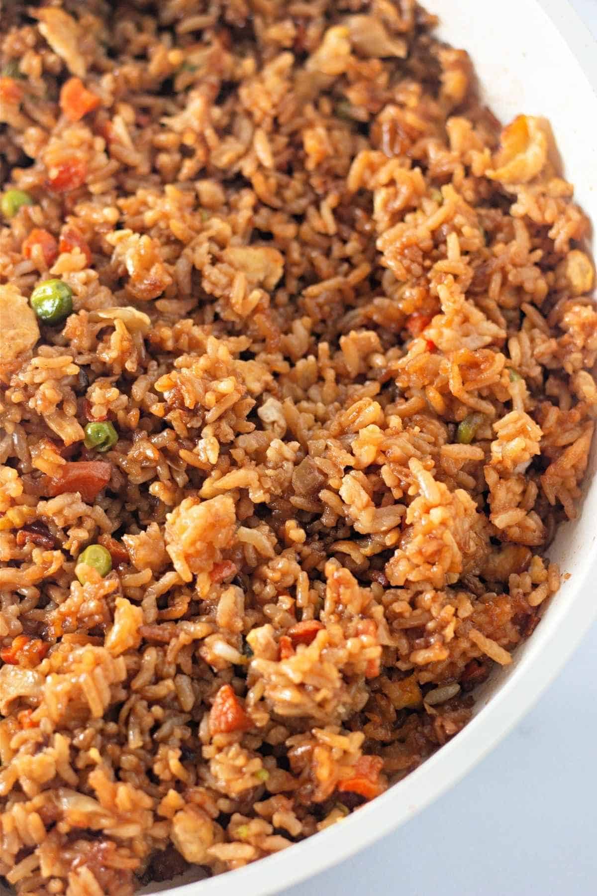 A white bowl filled with Fried rice.