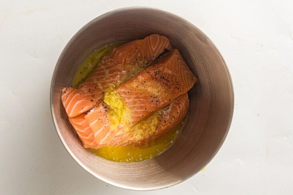 Fresh salmon fillets seasoned with lemon and spices, prepared for healthy eating.