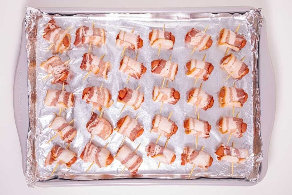 Little smokie wrapped with a piece of bacon and secured with toothpicks.