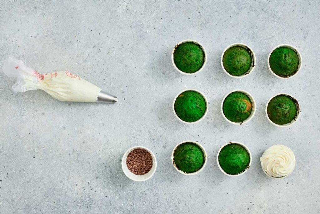 Decorative green dessert cups with whipped cream topping, ideal for snacks and celebrations.