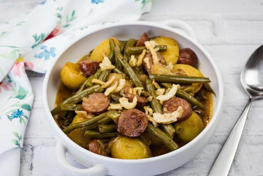 Friendly sausage and potato stew with green beans and herbs.