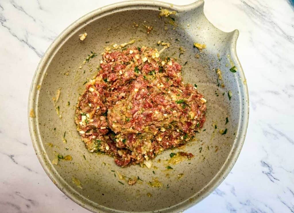 Use clean hands or a sturdy silicone spatula to mix everything together just until combined gently. Do not overmix or the meatballs will be tough.