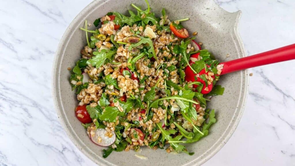 Add the farro to the bowl along with the shaved Parmesan and chopped pistachios.