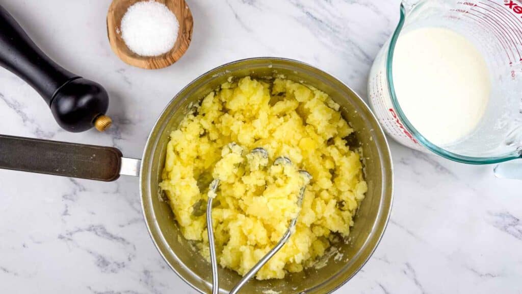 Mash the potatoes until mostly smooth, then pour in the cottage cheese mixture and stir until fully combined.
