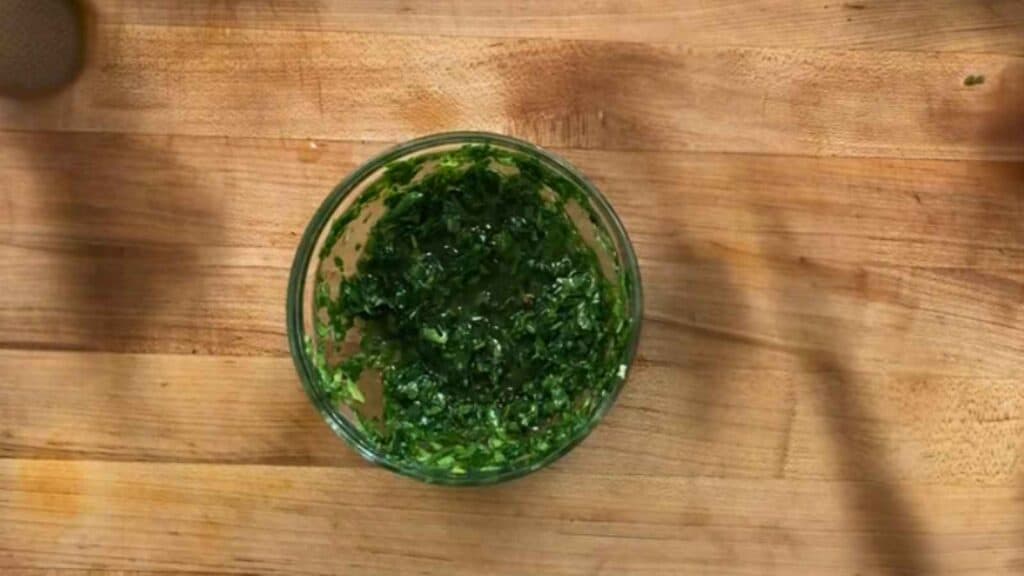 Stir the parsley, cilantro, garlic, lime juice, red pepper flakes, and salt together, then whisk in the olive oil.