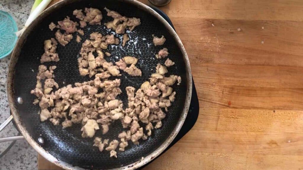 Brown the turkey sausage in a large skillet over medium heat.