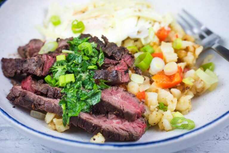 Close-up shot of Steak and Eggs Breakfast Bowl on a plate.
