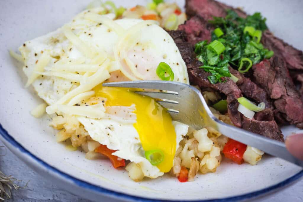 Steak and Eggs Breakfast Bowl on a white plate.