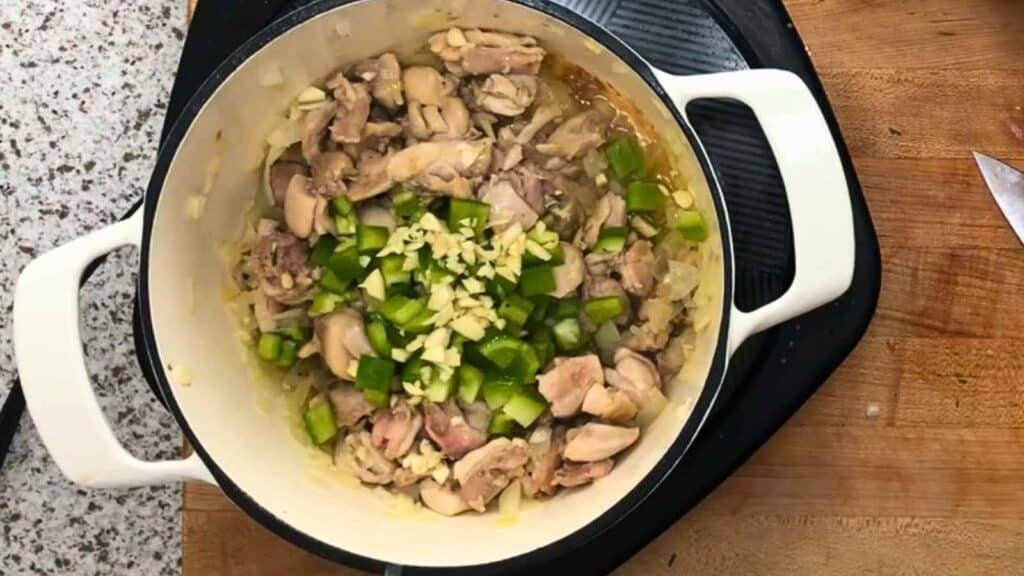Cook the onion until softened, then add the bell pepper and jalapeño.