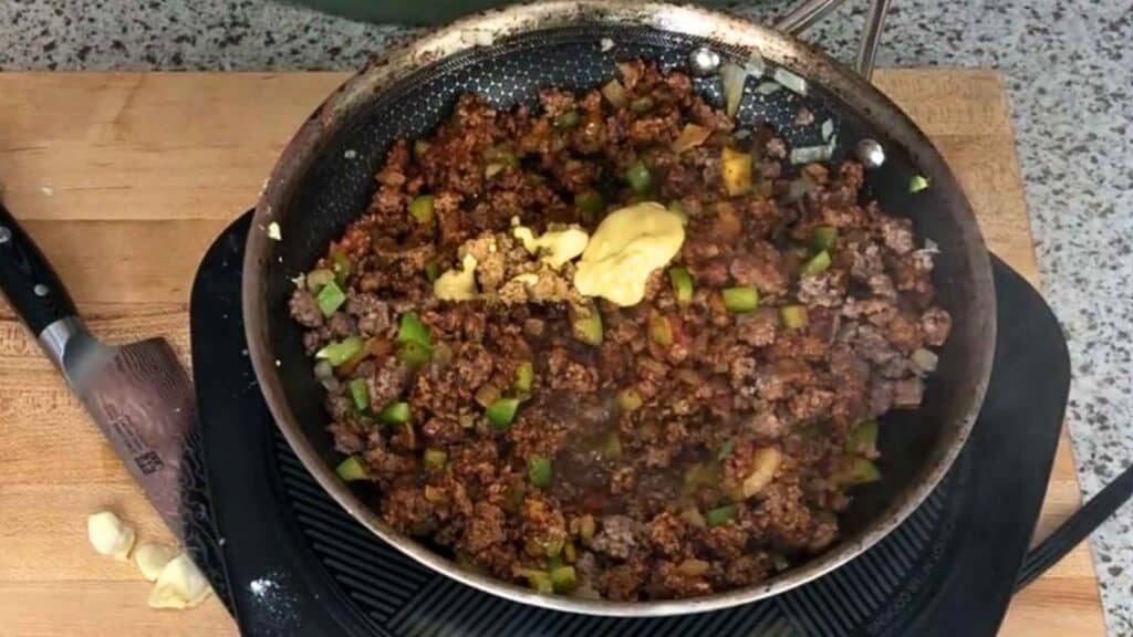 Stir in the tomato paste and let it cook for a full minute before adding anything else.